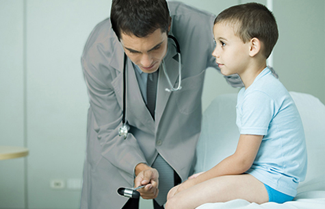 doctor-examining-boy-knee-reflexes-pediatric-neurology